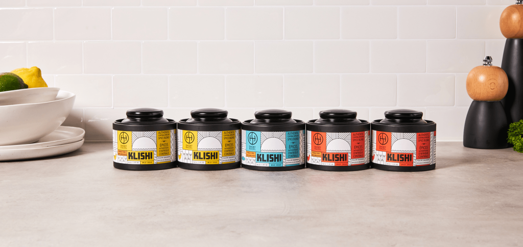 On a kitchen counter, 5 jars of Smokey Hazel’s ‘KLISHI’ spice blends.