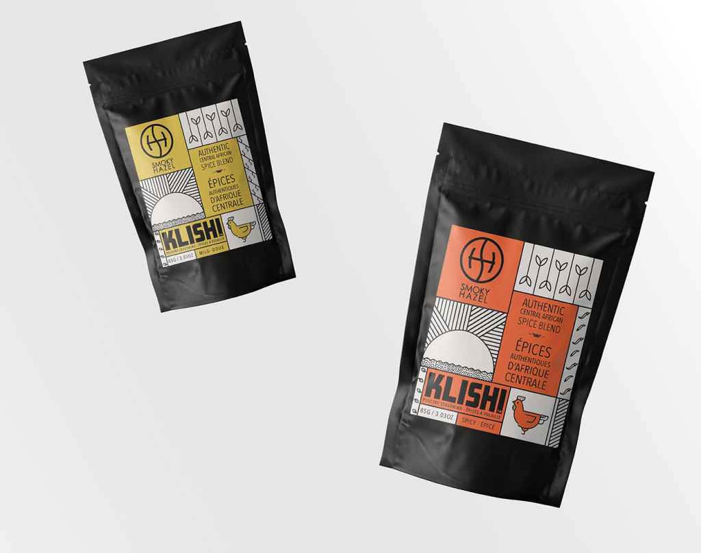 On a white background, two packets of the KLISHI spice blend. Both black bags feature different packaging, one in yellow and one in red, along with black and white graphics on each and the Smokey Hazel logo.